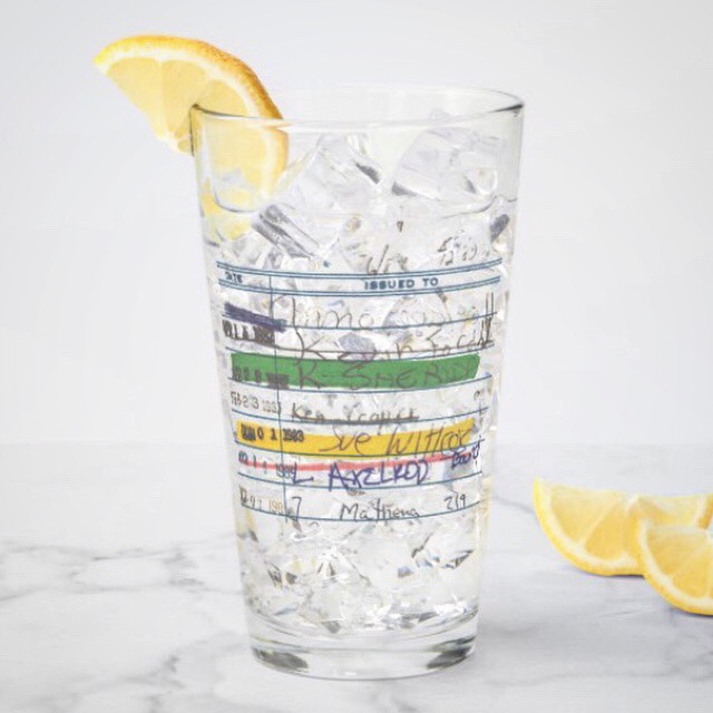 Pint glass with partially transparent library card artwork